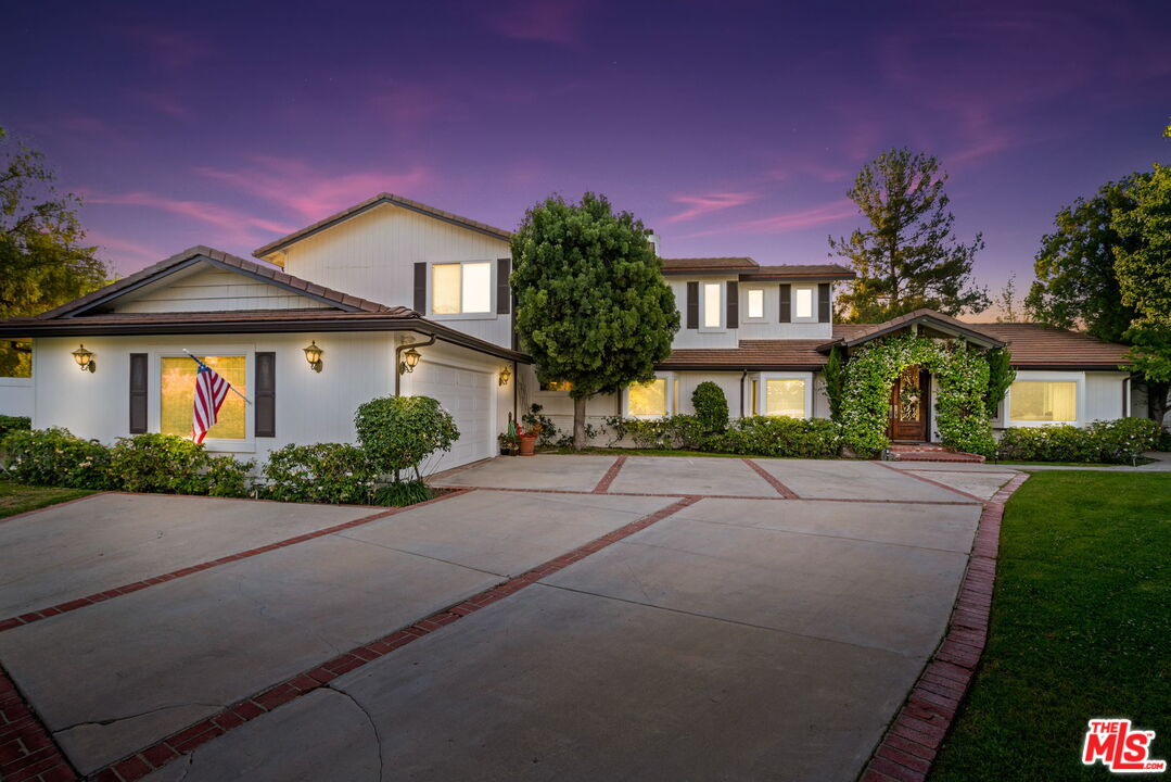 5845 Hilltop Road Hidden Hills, CA 91302 - Photo 15 of 16 a front view of a house with yard and green space