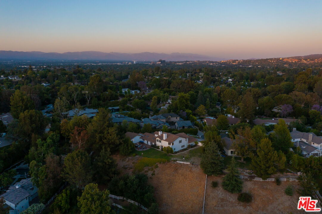 5845 Hilltop Road Hidden Hills, CA 91302 - Photo 16 of 16 a view of a city with lush green forest