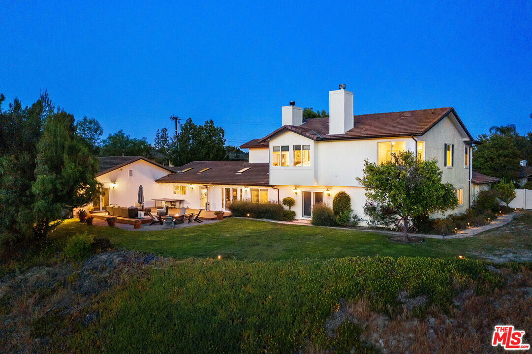 5845 Hilltop Road Hidden Hills, CA 91302 - Photo 2 of 16 a front view of a house with a yard and garage
