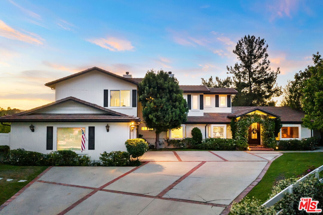 5845 Hilltop Road Hidden Hills, CA 91302 - Photo 7 of 16 a front view of a house with a yard