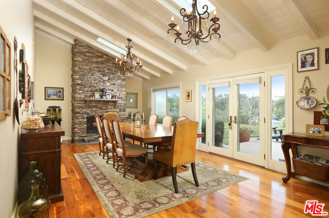 5845 Hilltop Road Hidden Hills, CA 91302 - Photo 9 of 16 a view of a dining room with furniture window and wooden floor