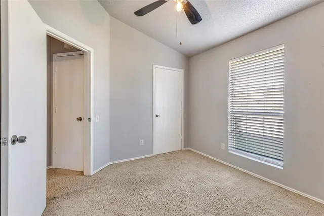 a view of a livingroom with a ceiling fan and window