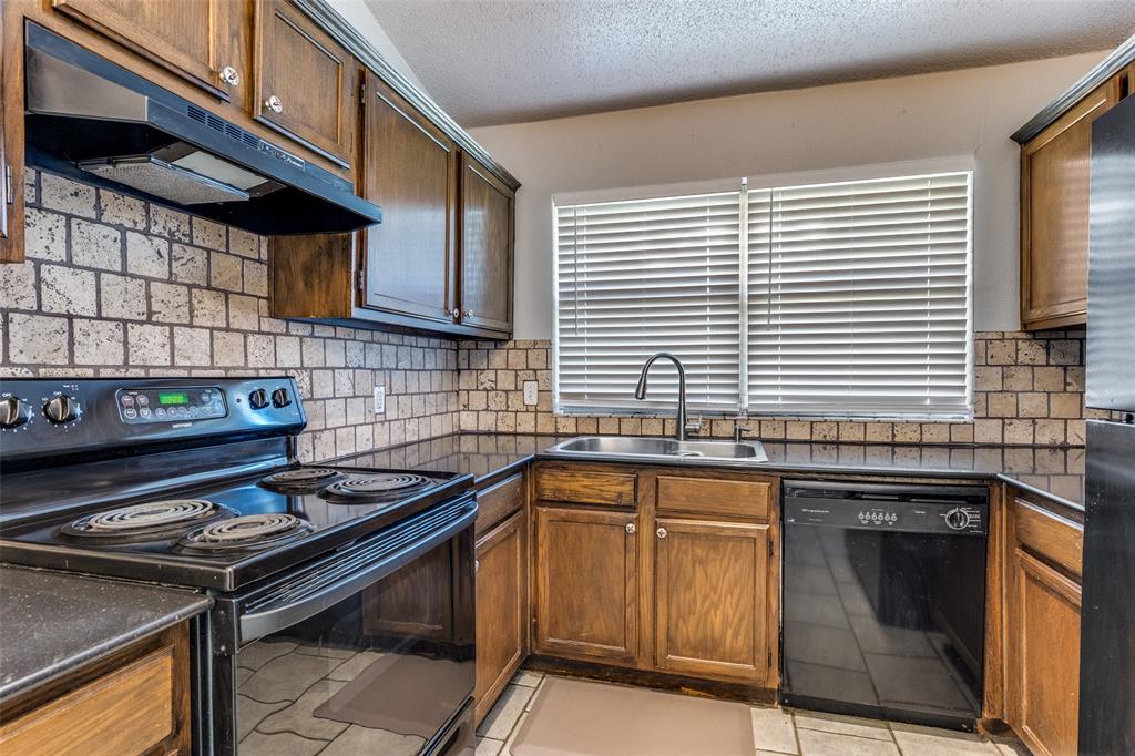 3820 River Birch Road Fort Worth, TX 76137 - Photo 5 of 22 a kitchen with a sink stove and cabinets