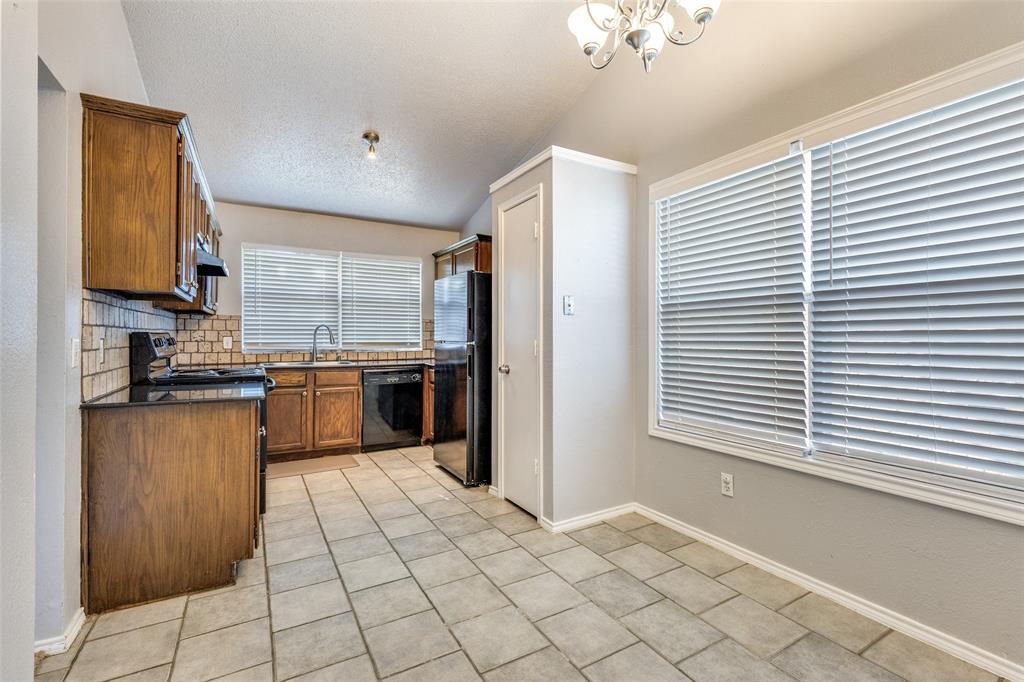 3820 River Birch Road Fort Worth, TX 76137 - Photo 6 of 22 a kitchen with stainless steel appliances granite countertop a refrigerator and a sink
