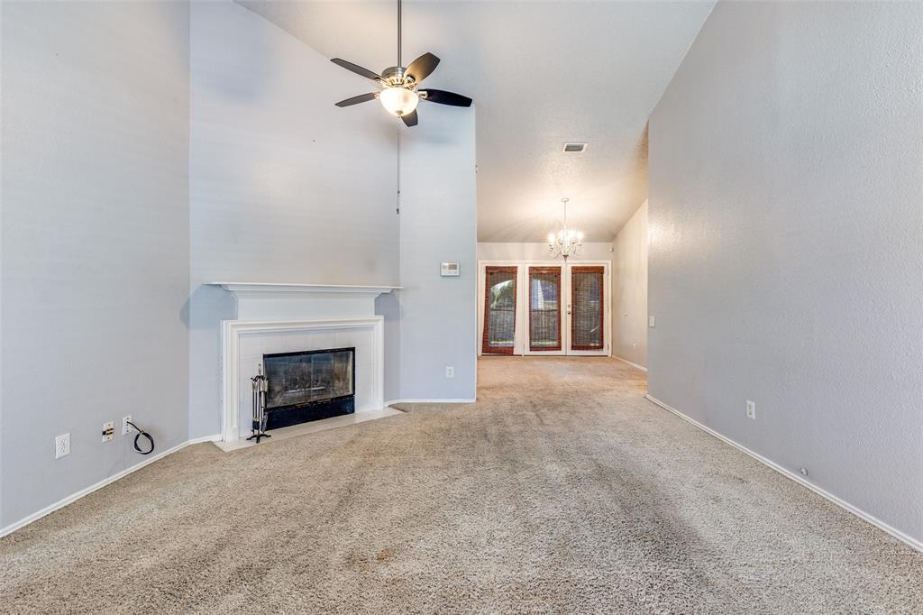 3820 River Birch Road Fort Worth, TX 76137 - Photo 9 of 22 an empty room with a fireplace and fan