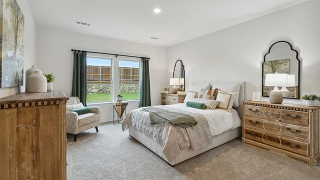 a bedroom with bed chair and window