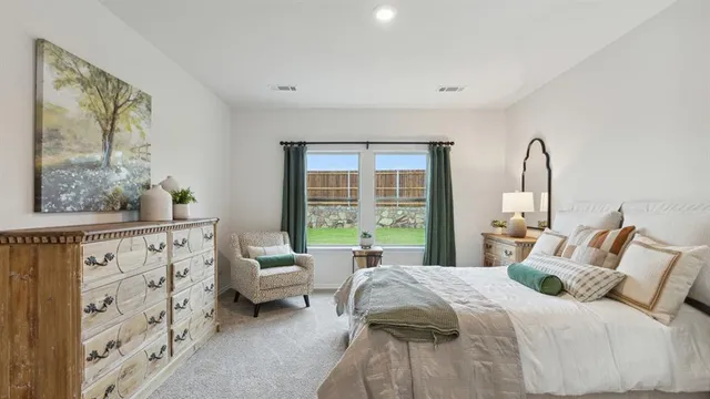 a bedroom with a bed couch and a window