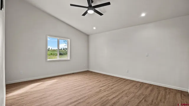 a view of a room with wooden floor