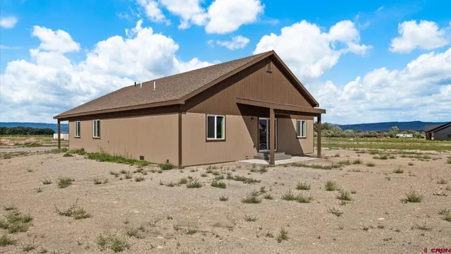 a front view of house with wooden fence