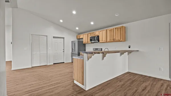 a view of a kitchen with a refrigerator and a window