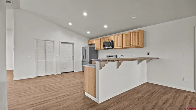 a view of a kitchen with a refrigerator and a window