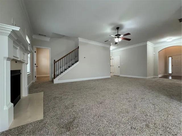 a view of an empty room with a fireplace