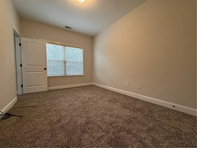 an empty room with a empty space and windows