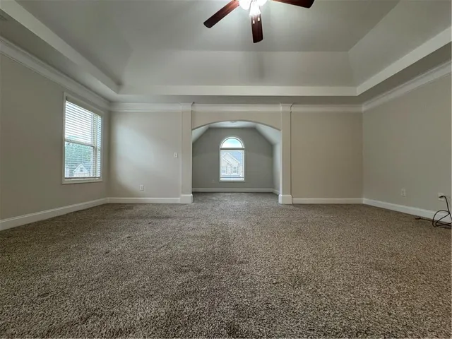an empty room with a empty space and chandelier fan