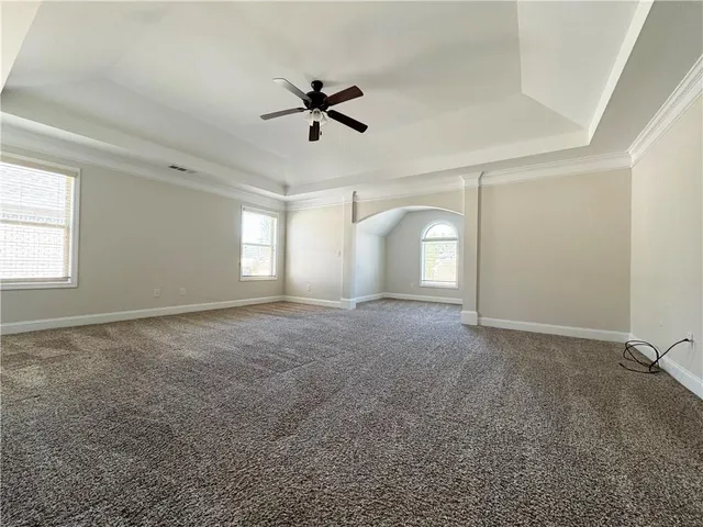 a view of a livingroom with a ceiling fan and window