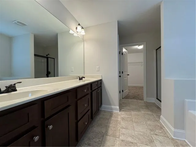 a bathroom with a bathtub and shower