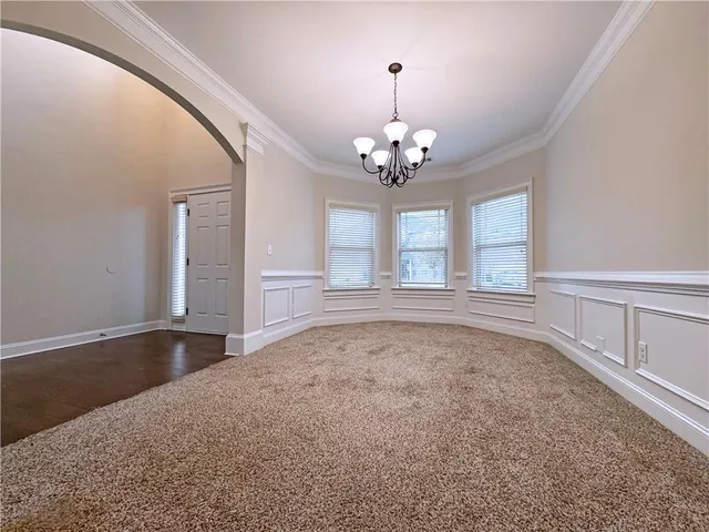 a view of an empty room with chandelier