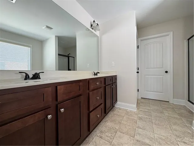 a spacious bathroom with a granite countertop sink and mirror