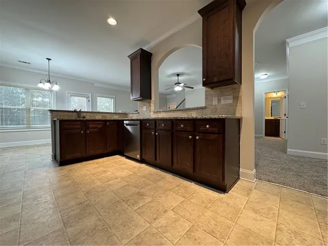 a kitchen with stainless steel appliances granite countertop a sink and cabinets