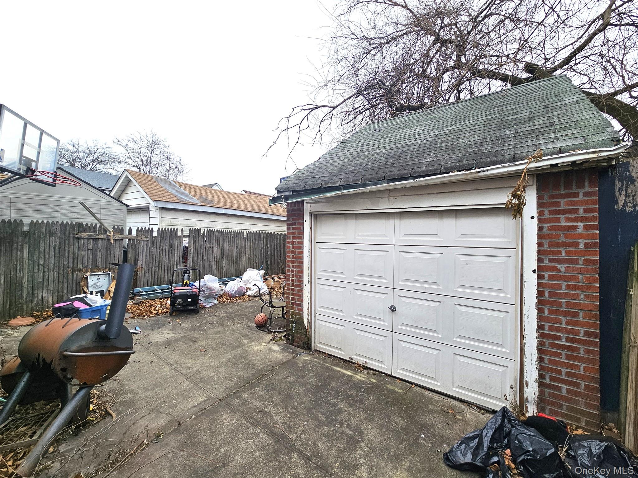 100-15 202nd Street Queens, NY 11423 - Photo 6 of 7 Garage featuring driveway