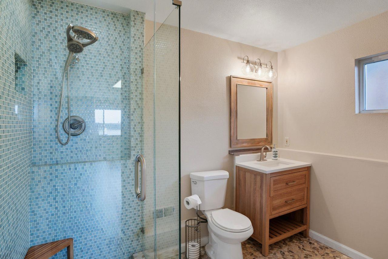 701 Archer Street Monterey, CA 93940 - Photo 20 of 39 a bathroom with a toilet sink a shower and mirror