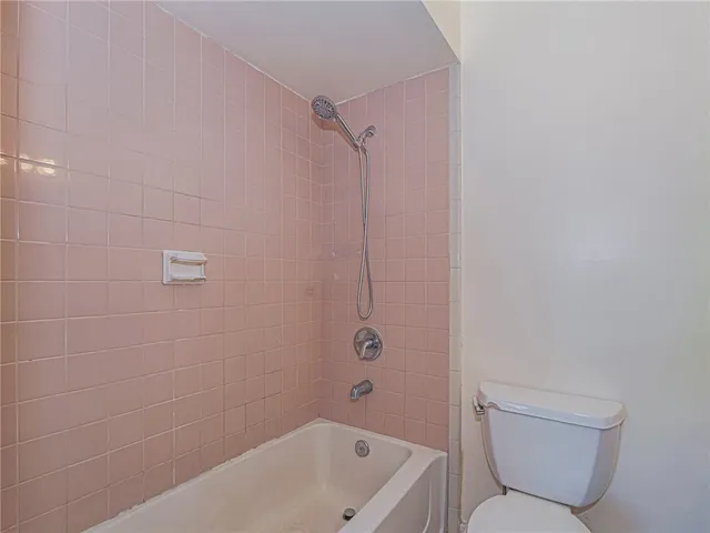 a bathroom with a toilet bathtub and shower