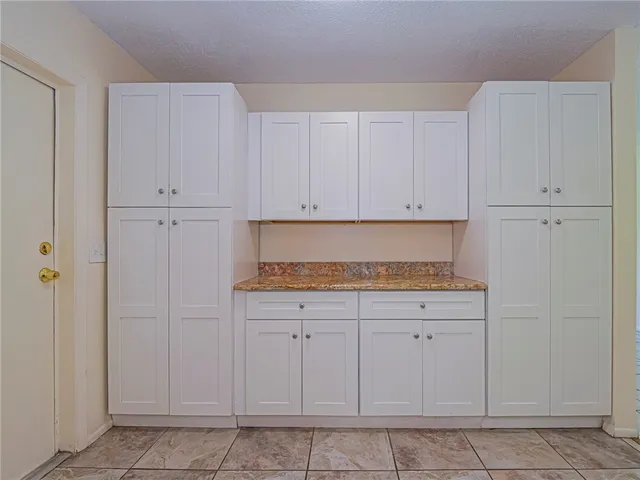 a kitchen with white cabinets