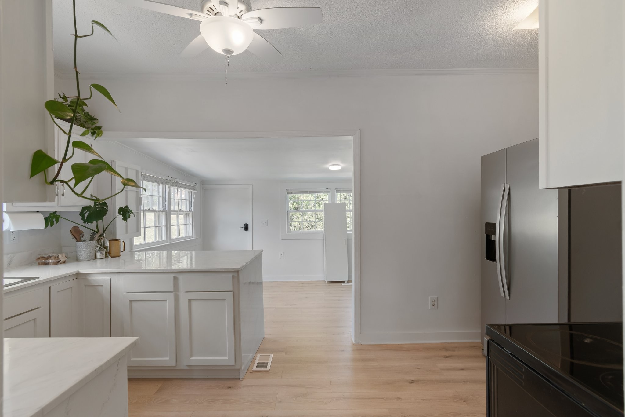 4711 Ollie Chunn Road Spring Hill, TN 37174 - Photo 17 of 64 a kitchen with stainless steel appliances a sink cabinets and wooden floor