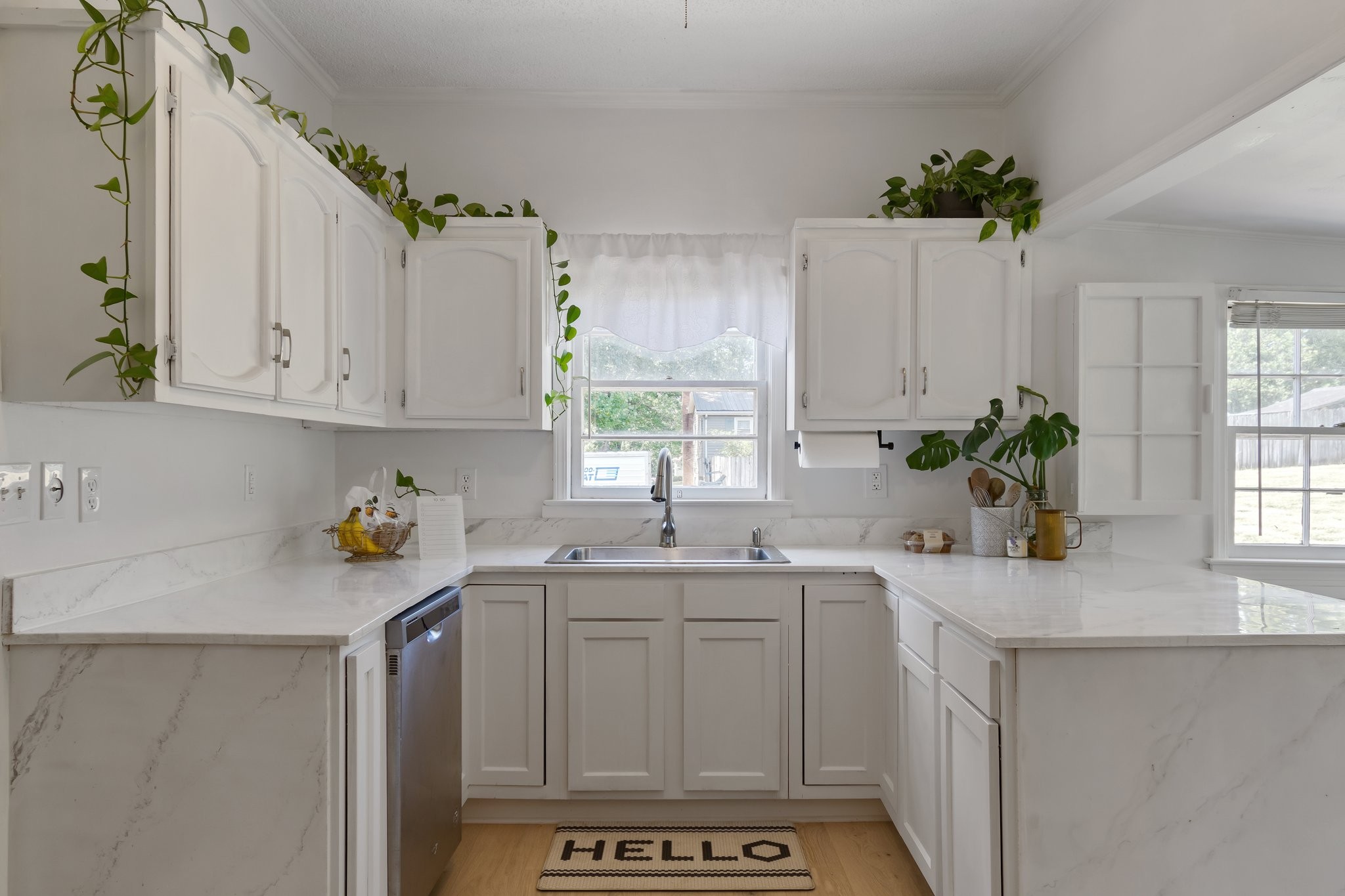 4711 Ollie Chunn Road Spring Hill, TN 37174 - Photo 19 of 64 a kitchen with a sink a window cabinets and white appliances