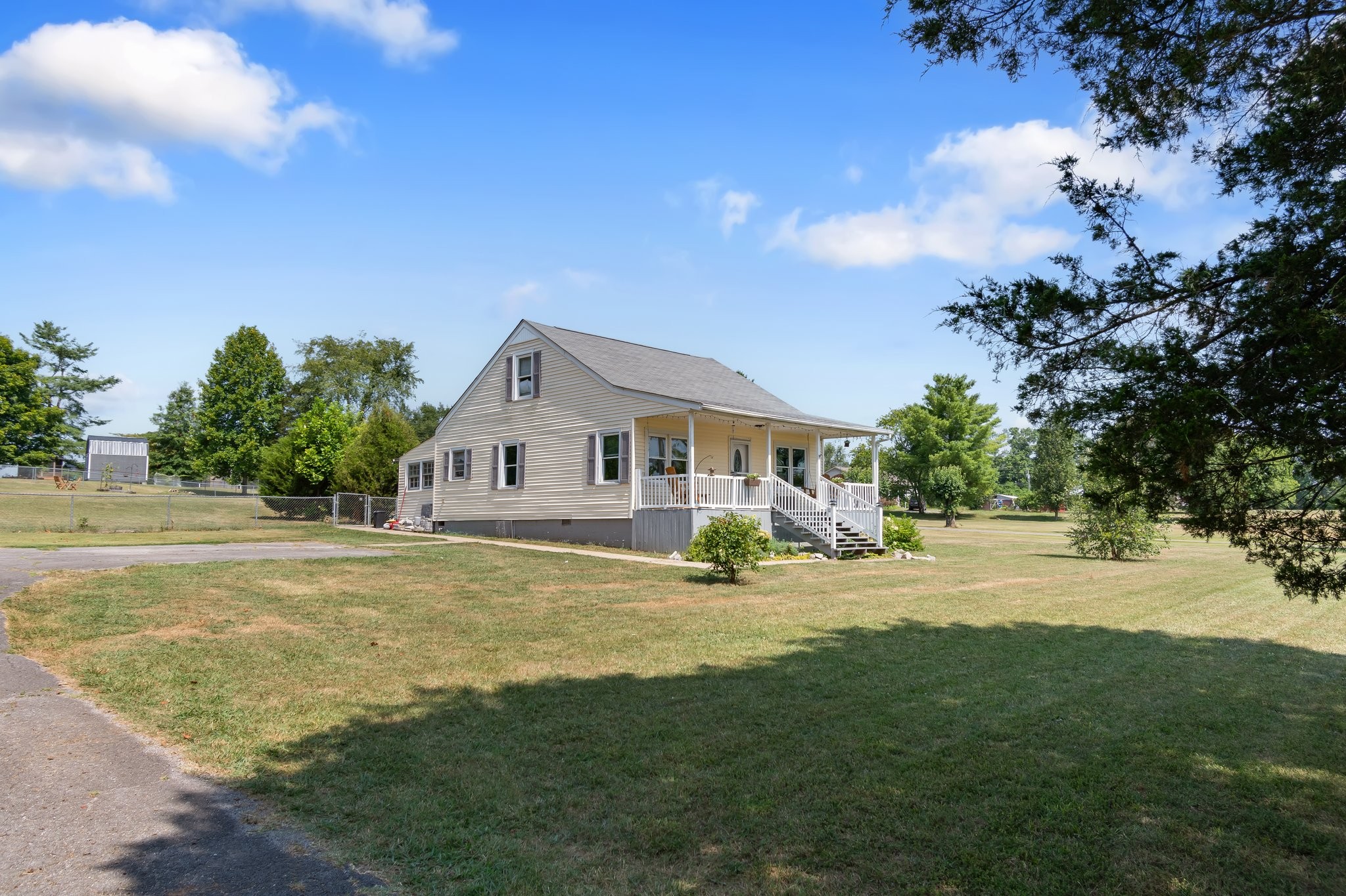 4711 Ollie Chunn Road Spring Hill, TN 37174 - Photo 43 of 64 a view of a house with a big yard and large trees