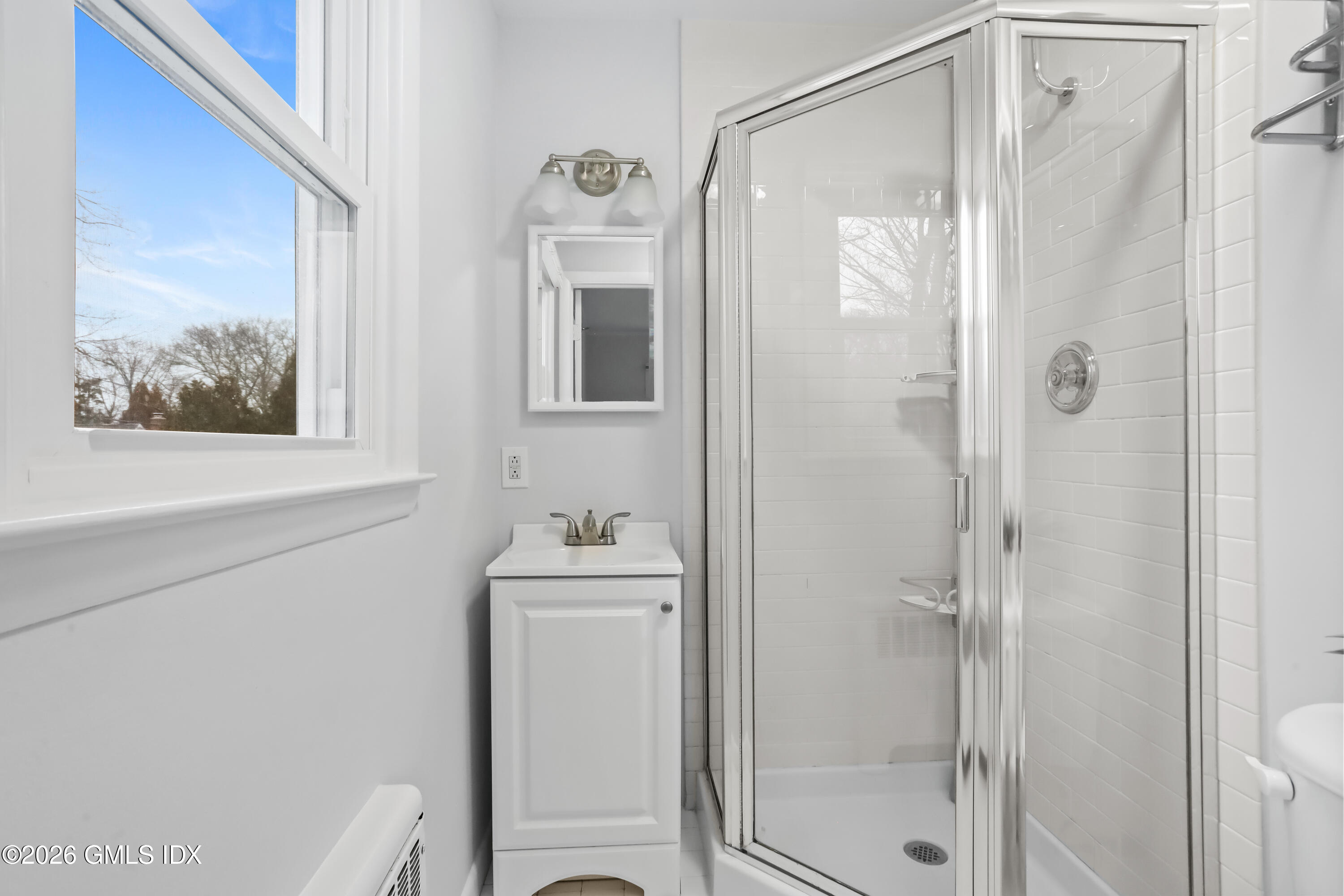 45 Sound Beach Ave Extension Riverside, CT 06878 - Photo 13 of 31 a bathroom with a shower a mirror and a sink