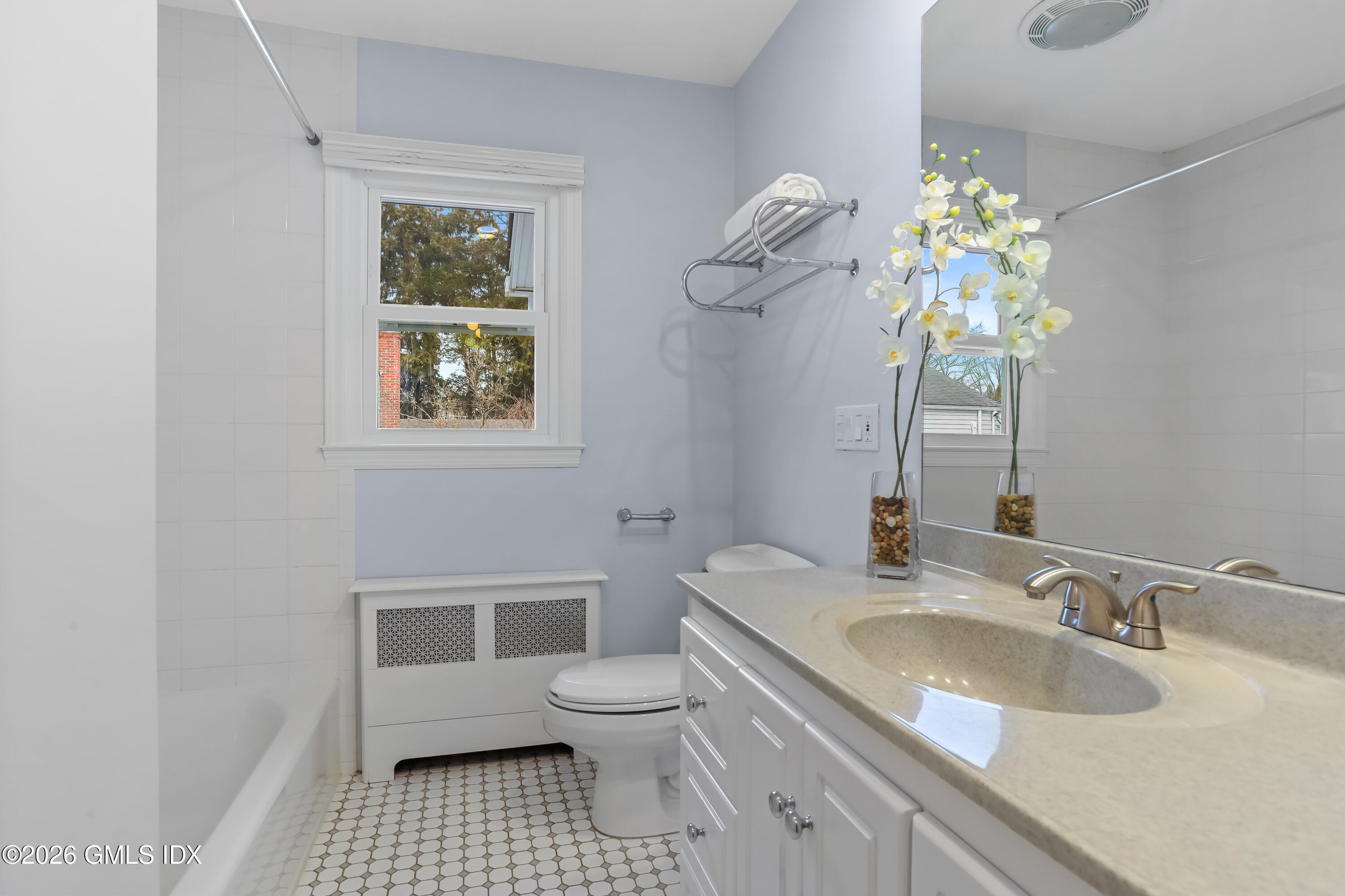 45 Sound Beach Ave Extension Riverside, CT 06878 - Photo 16 of 31 a bathroom with a sink a toilet and a mirror