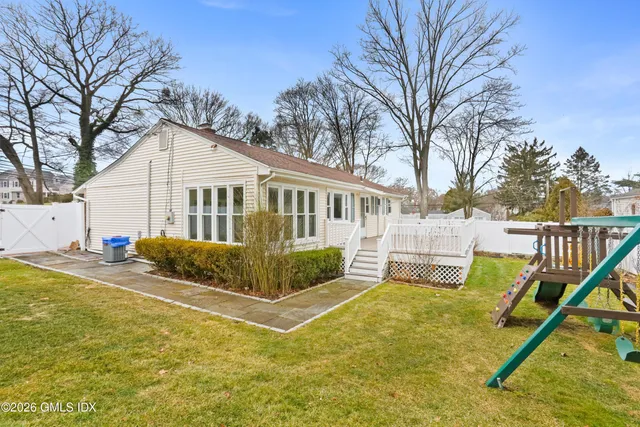 a view of house with backyard and trees