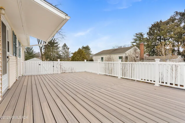 a view of backyard with a deck and wooden floor