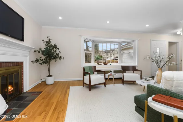 a living room with furniture a fireplace and a flat screen tv