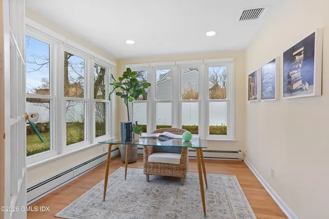 a living room with furniture and a large window with outer view
