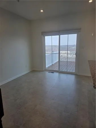 an empty room with wooden floor and a window