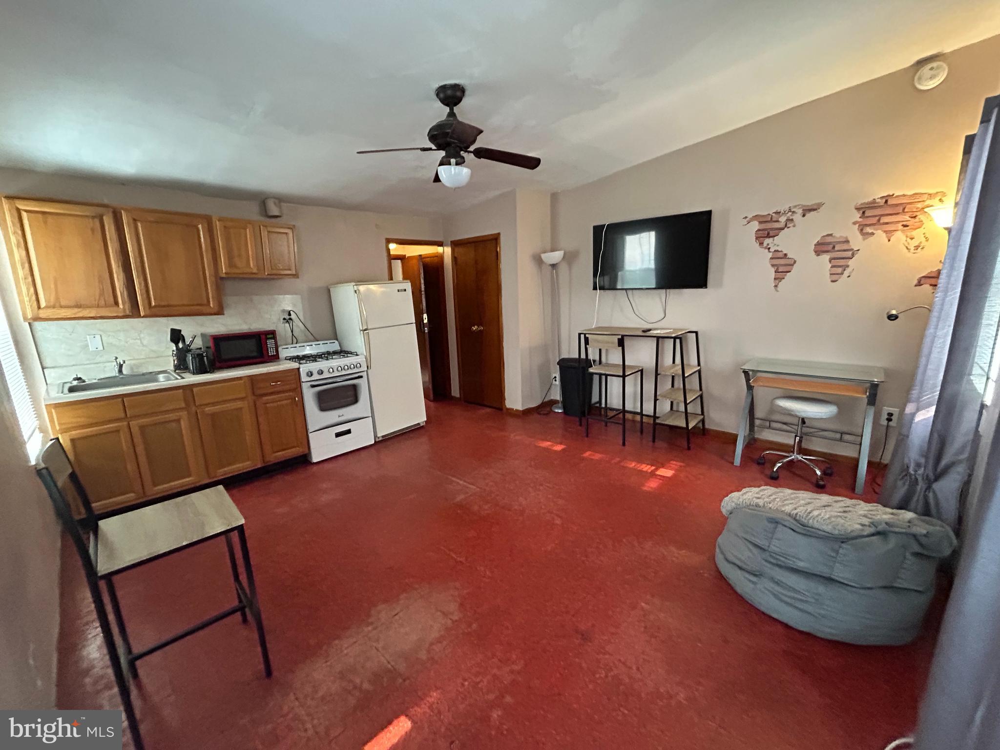 532 North 15th Street, Unit 3F Philadelphia, PA 19130 - Photo 1 of 8 a living room with furniture and a flat screen tv