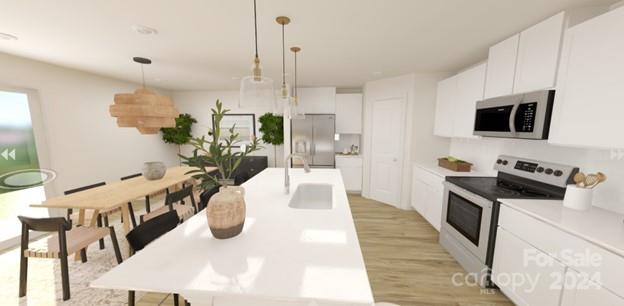 2356 Trollinger Drive Catawba, NC 28609 - Photo 2 of 7 a kitchen with stainless steel appliances kitchen island granite countertop a stove a sink a microwave with a dining table and chairs