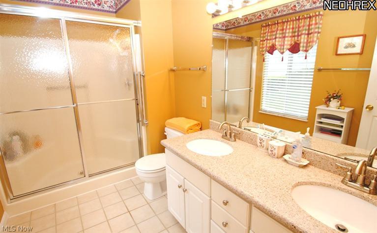 675 Briar Ridge Lane Akron, OH 44313 - Photo 11 of 20 The tile floored master bath features a large shower and double vanity with granite counters.