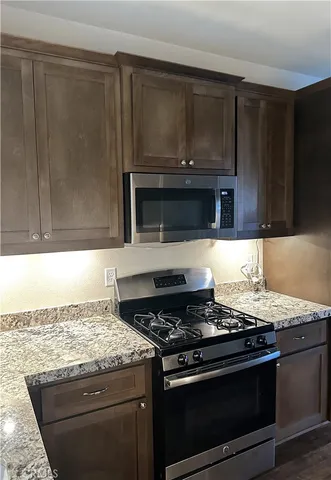 a stove top oven sitting inside of a kitchen