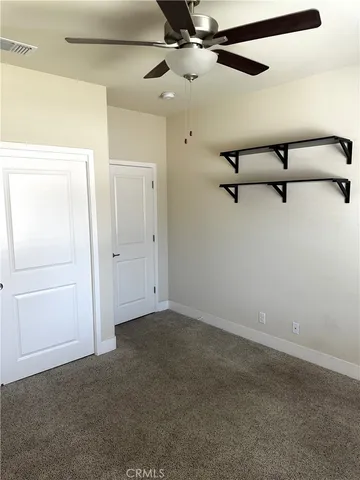 an empty room with a ceiling fan