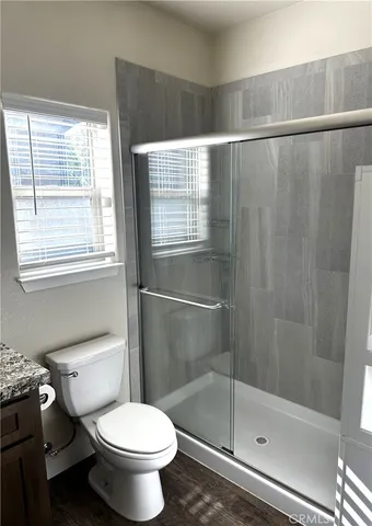 a bathroom with a toilet and a shower