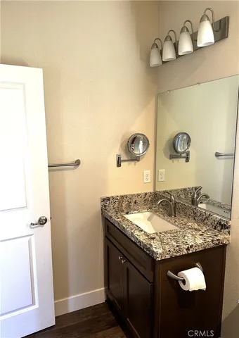 a bathroom with a granite countertop sink and a mirror