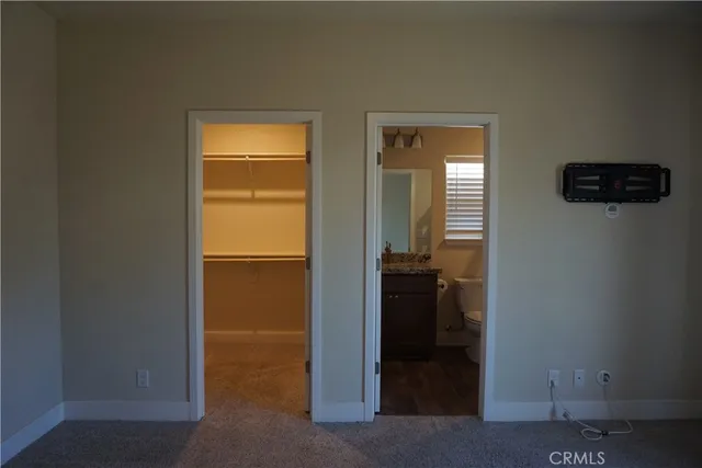 a view of a hallway with wooden floor and a livingroom