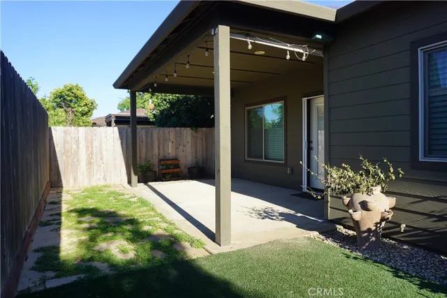 a view of a backyard with plants and outdoor seating