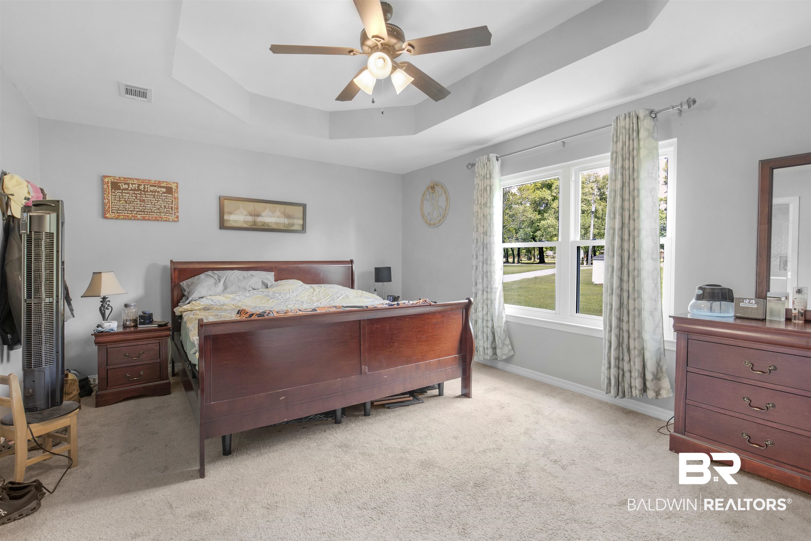 13925 Fort Lake Road Grand Bay, AL 36541 - Photo 10 of 37 Bedroom with visible vents, light carpet, baseboards, a raised ceiling, and a ceiling fan