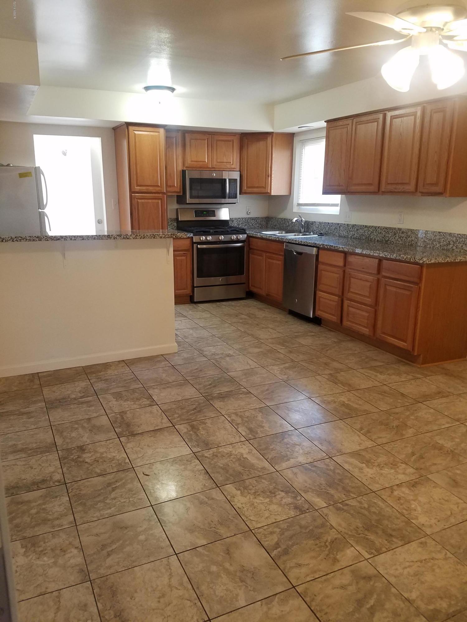 395 East Foster Road Santa Maria, CA 93455 - Photo 2 of 11 a kitchen with stainless steel appliances granite countertop a sink a stove a microwave a counter top space cabinets and a window