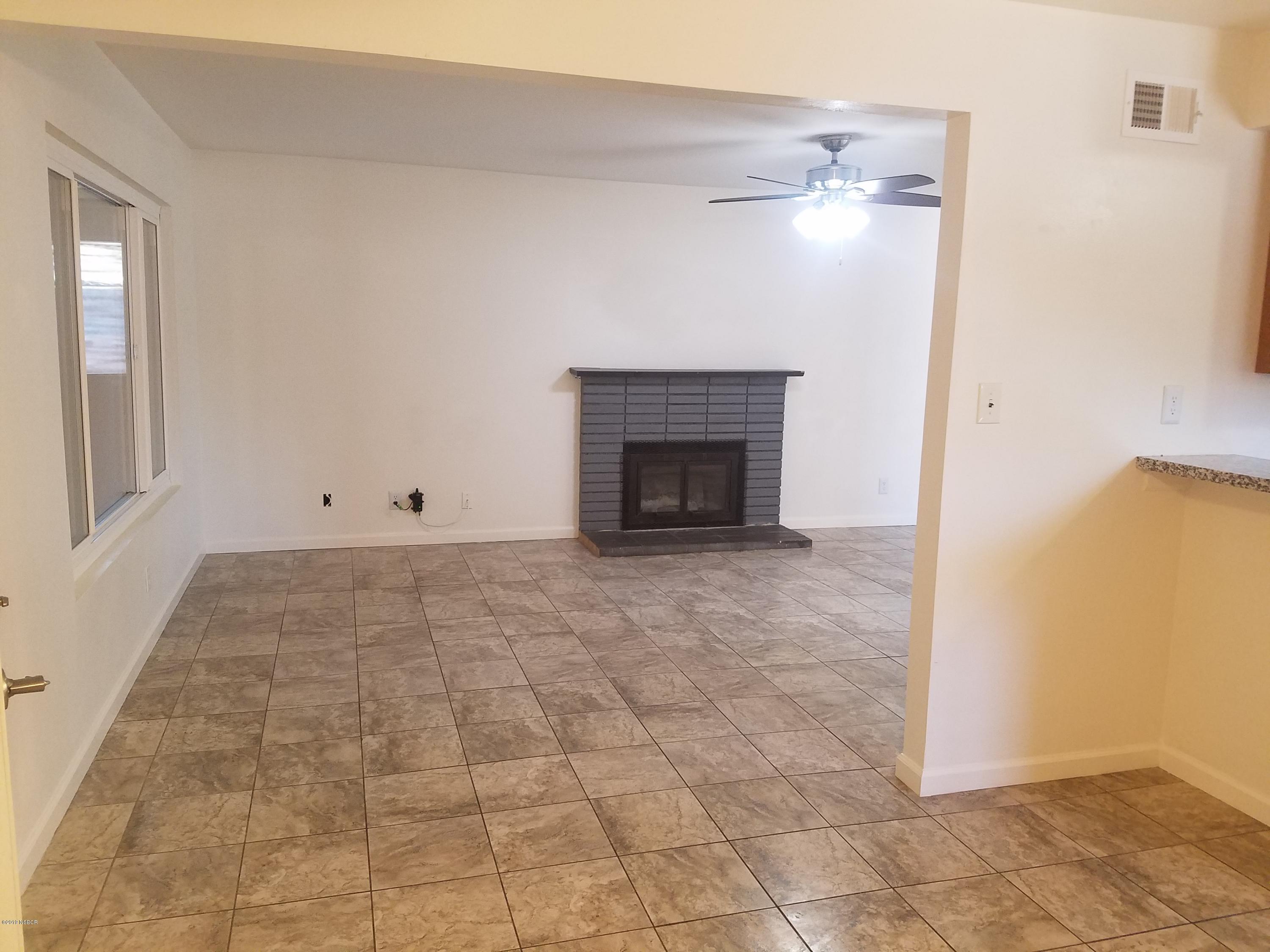 395 East Foster Road Santa Maria, CA 93455 - Photo 4 of 11 a view of an empty room with a fireplace