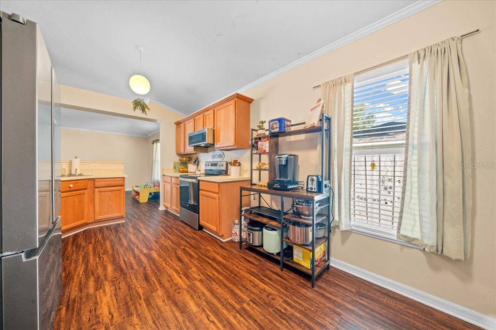49 Hemlock Radial Loop Ocala, FL 34472 - Photo 15 of 50 a view of a kitchen with workspace and wooden floor